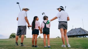 family practicing golf together